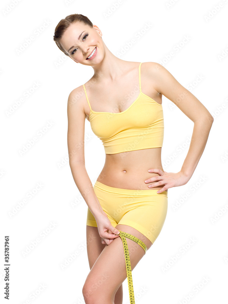 Fototapeta premium woman measuring hip by tape after fitness