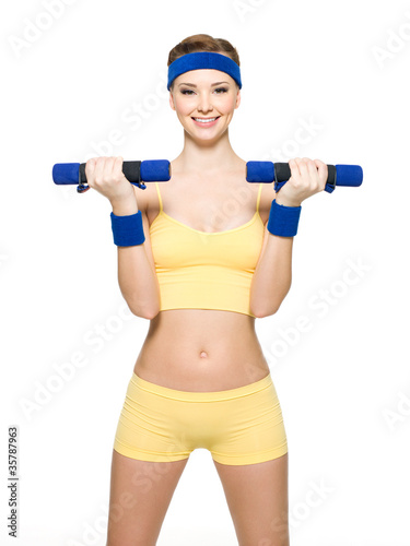 Woman doing fitness exercise with dumbbells