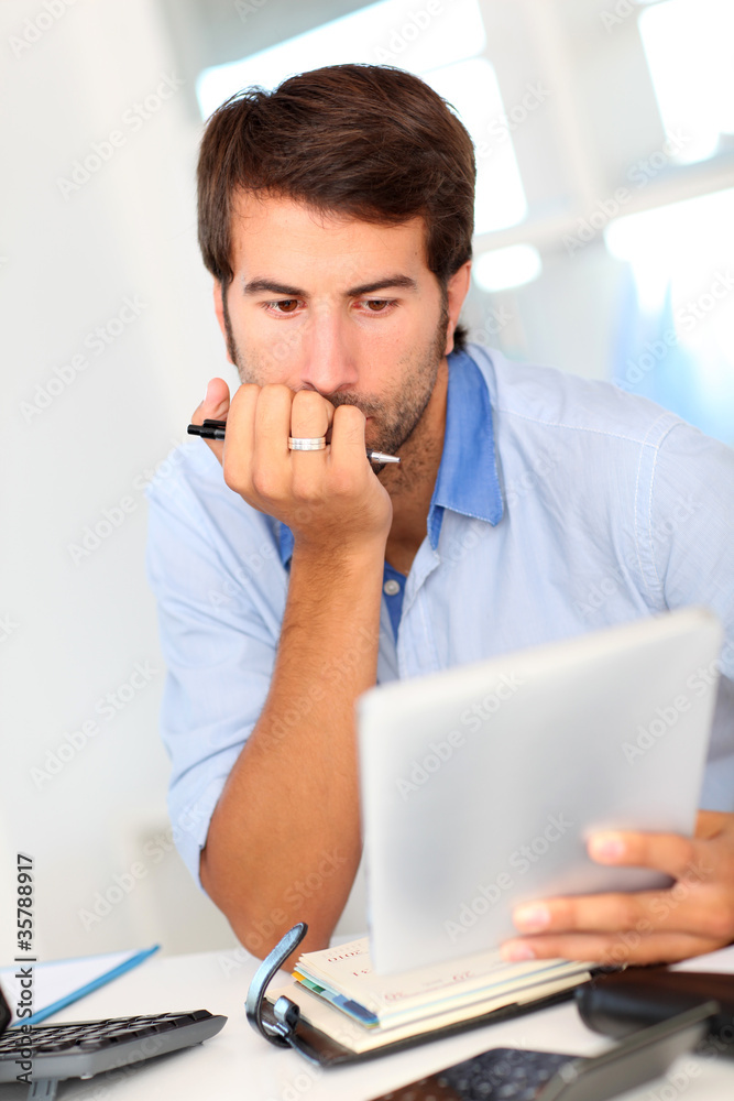 Portrait of office worker using electronic tablet Portrait of office worker using electronic tablet