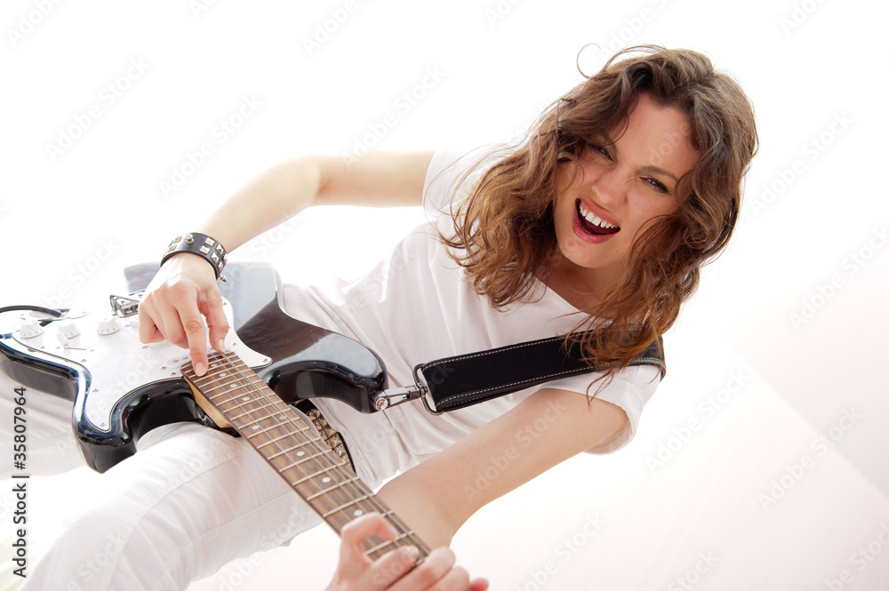 Fototapeta premium Portrait of beautiful young and attractive womanplaying her guit