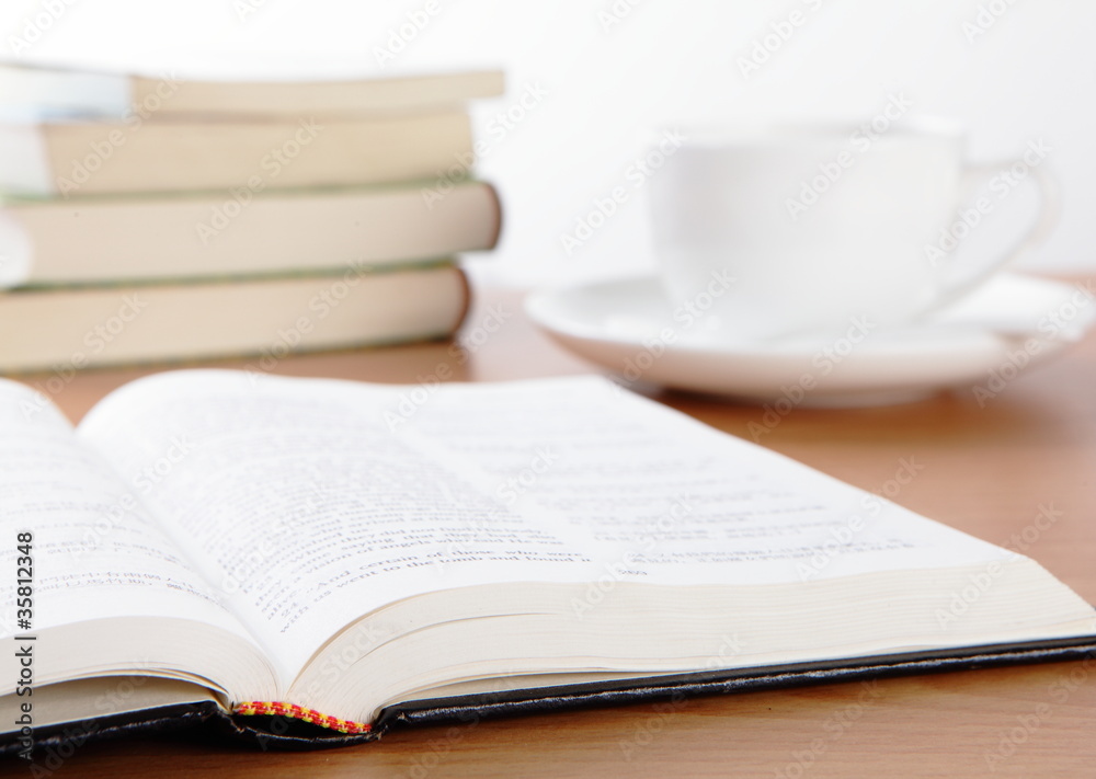Cup book and plant on wooden table Cup book and plant on wooden table