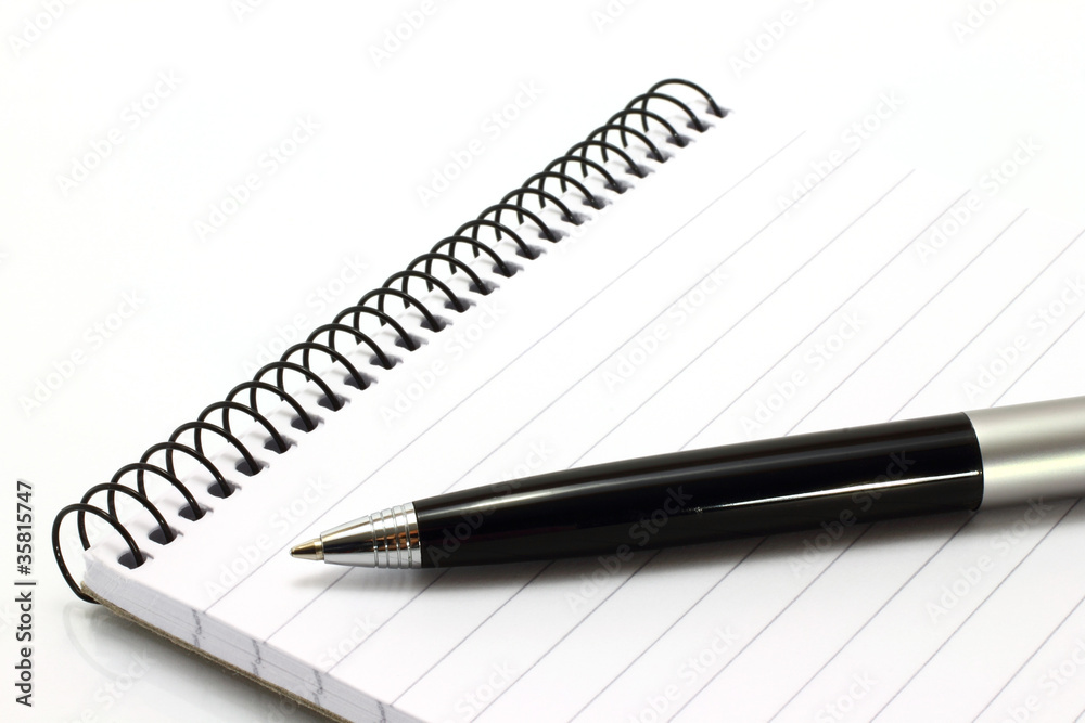 Notepad with ball pen on a white background Notepad with ball pen on a white background