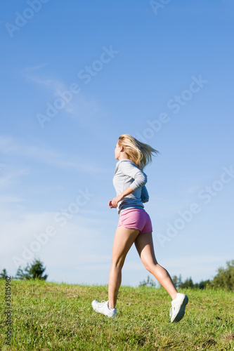 Jogging young sportive woman meadows sunny day