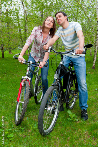 Happy young couple riding bicycles