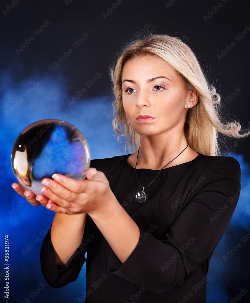 Naklejka premium Young woman with crystal ball.