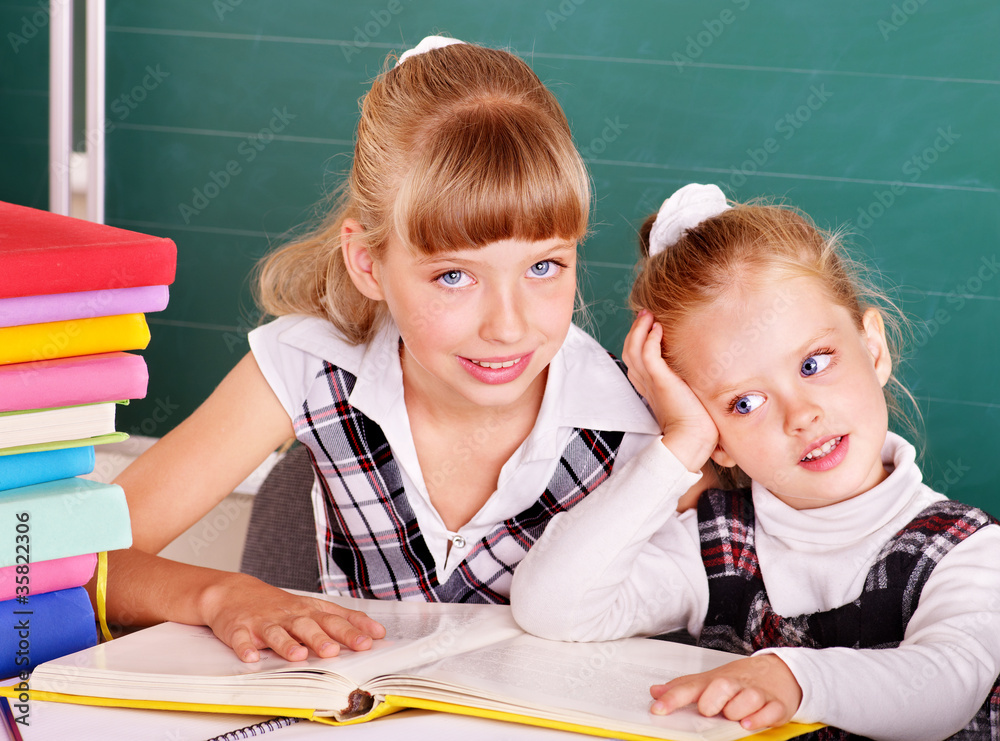 Schoolchildren in classroom near blackboard. Schoolchildren in classroom near blackboard.