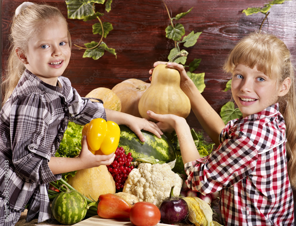 Fototapeta premium Child with vegetable on kitchen.