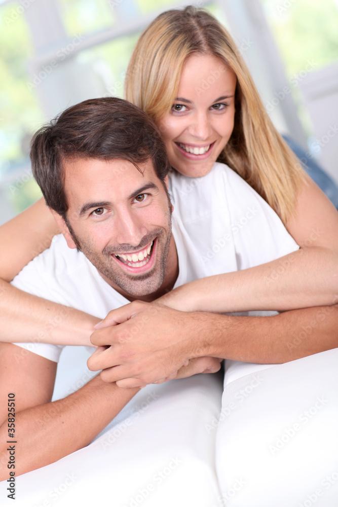 Fototapeta premium Young couple laying down sofa