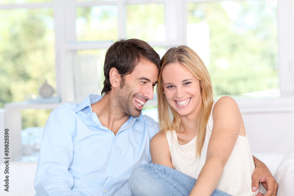 Young couple relaxing in sofa at home
