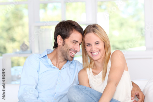 Free Download Young couple relaxing in sofa at home - GFXLoad