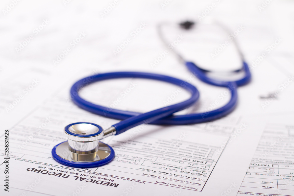 A prescription form and stethoscope on a doctor's desk A prescription form and stethoscope on a doctor's desk