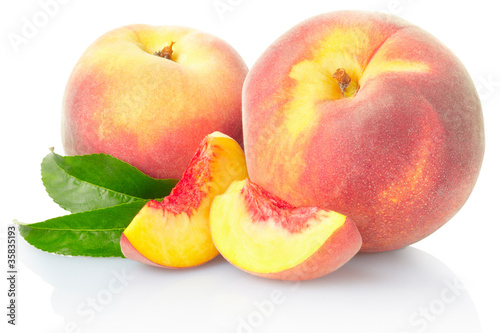 Peach fruits with leaves on white with clipping path