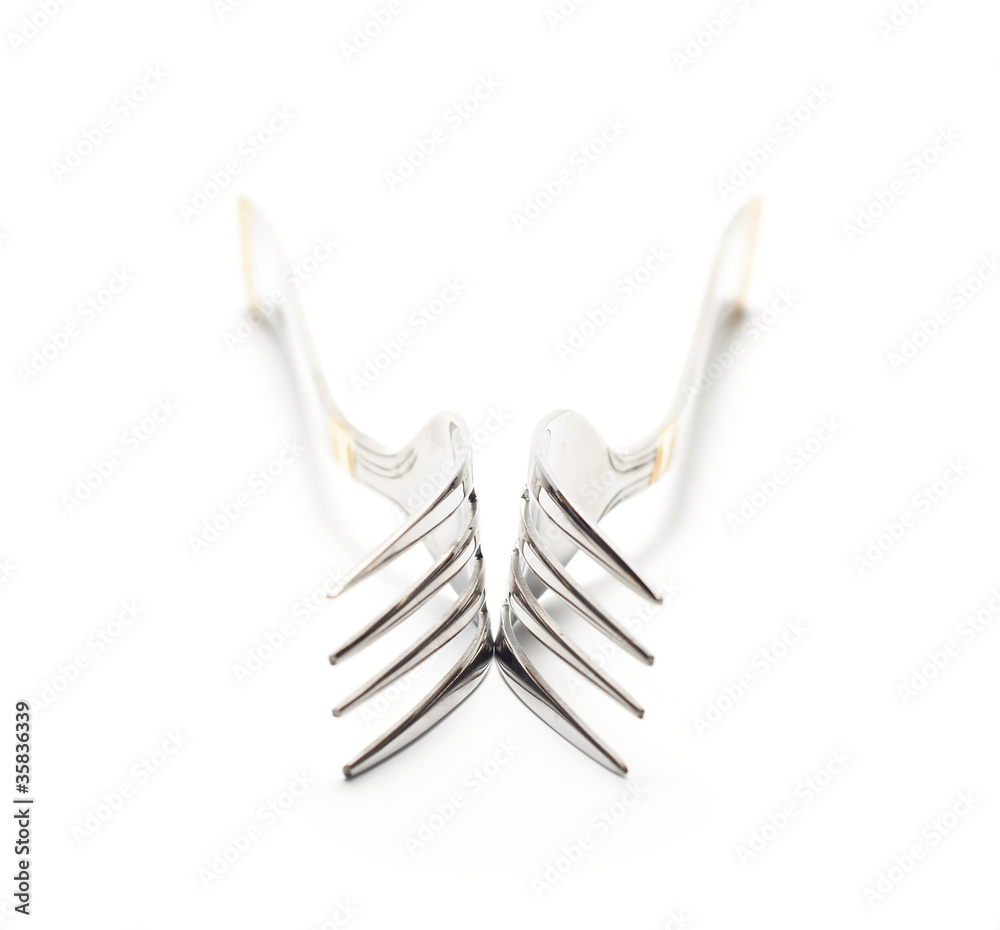 Two forks isolated on white. High key. Handle out of focus Two forks isolated on white. High key. Handle out of focus
