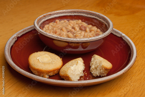 Classic bean soup and buttered cornbread on dish