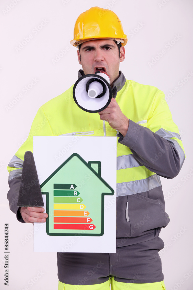 craftsman holding an energy consumption label and a megaphone craftsman holding an energy consumption label and a megaphone