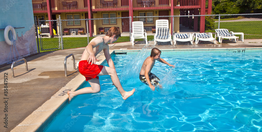 Naklejka premium brothers have fun jumping in the pool