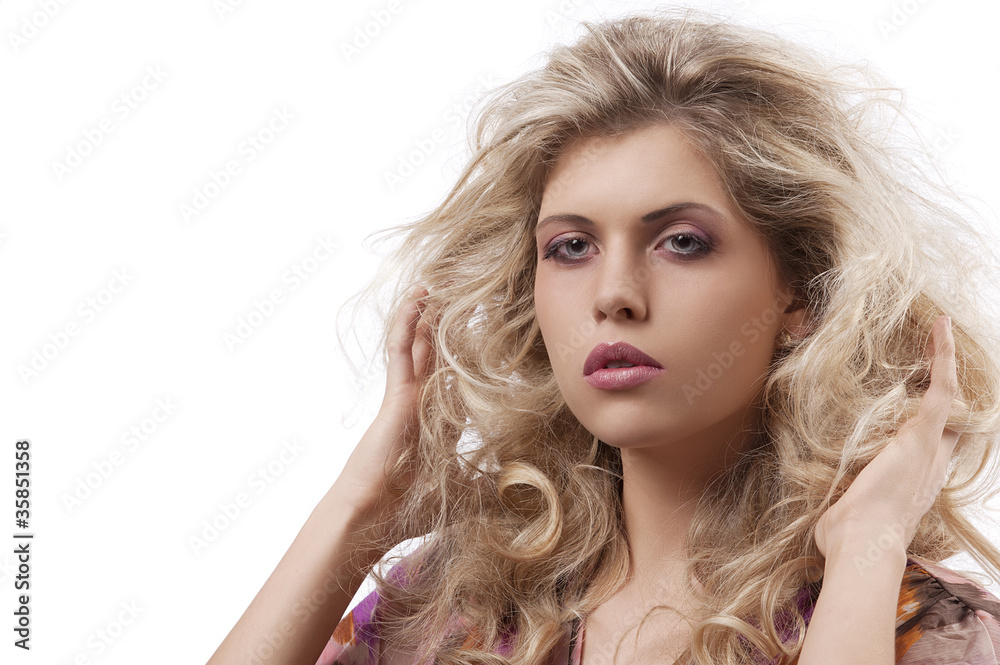 beautiful woman with long curly blond hair posing towards camera beautiful woman with long curly blond hair posing towards camera