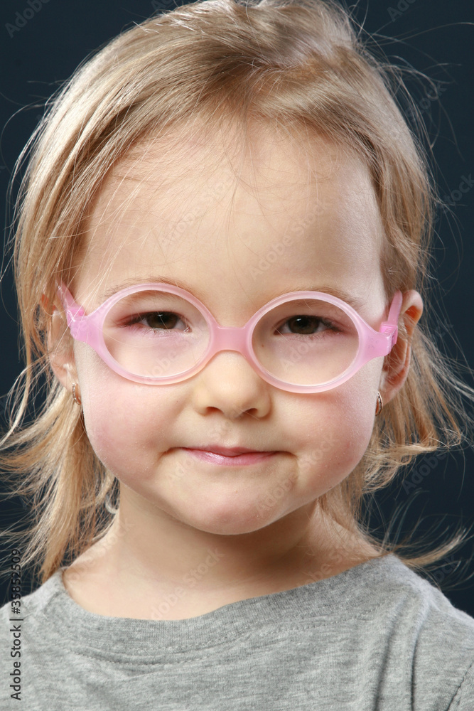 Cute little girl portrait in pink glasses Cute little girl portrait in pink glasses