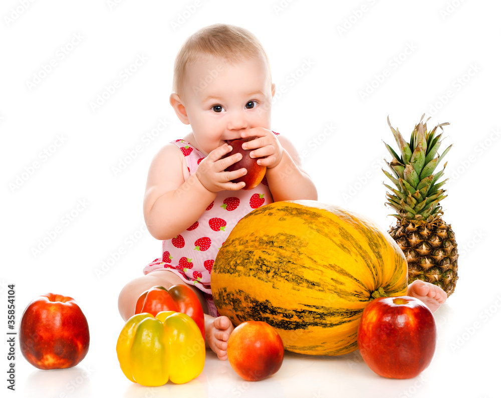 Fototapeta premium small child with vegetables and fruits