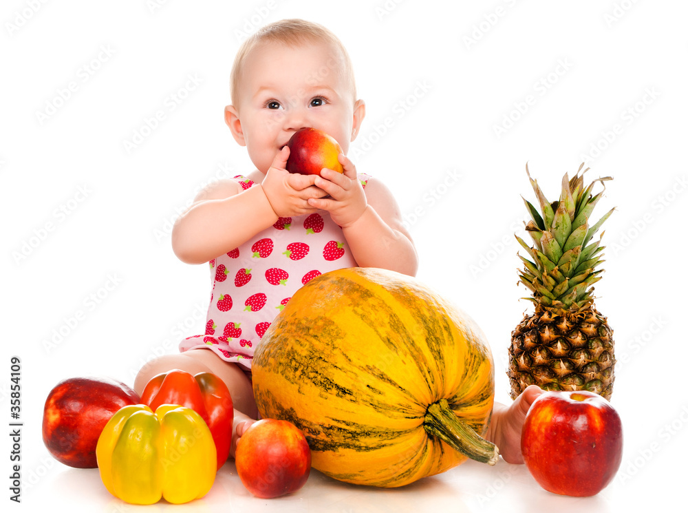 Fototapeta premium small child with vegetables and fruits