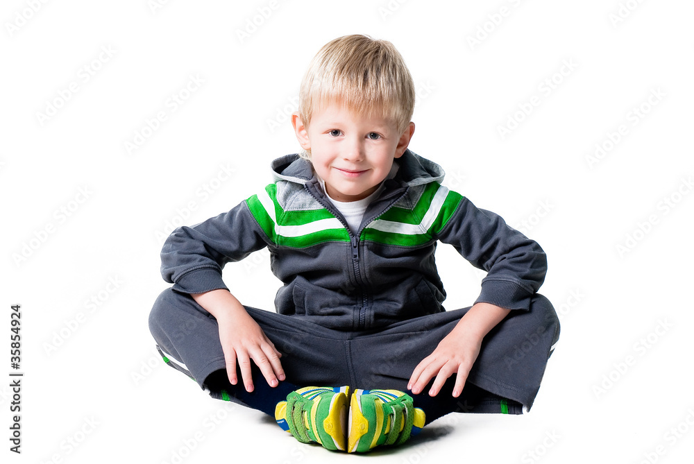 happy sportive boy sitting on floor on white background happy sportive boy sitting on floor on white background
