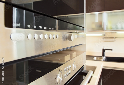 Build in microwave oven in modern kitchen interior with hardwood