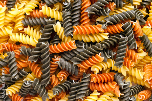 Tri-colored spiral pasta covering screen photo