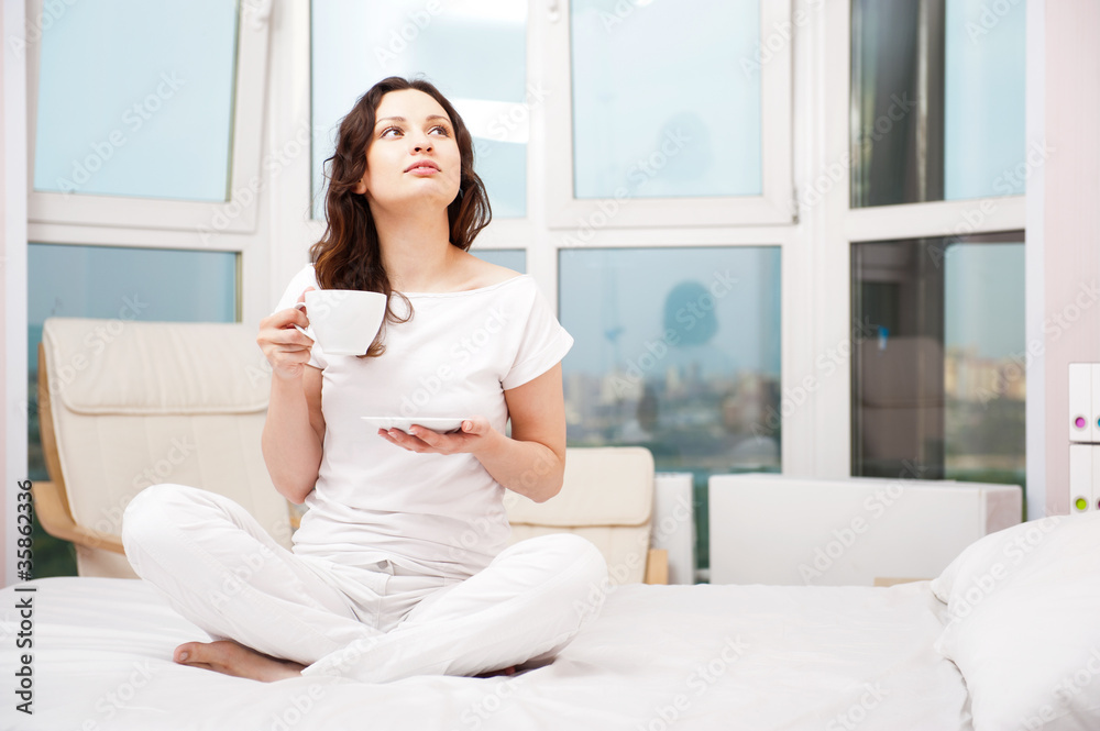 Closeup portrait of a pretty young female having a cup of coffee Closeup portrait of a pretty young female having a cup of coffee