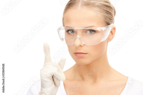 woman in protective glasses and gloves