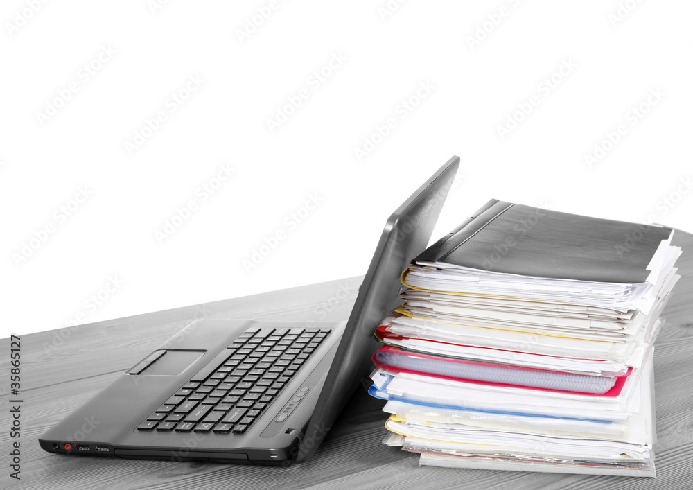 Many files and a computer on a desk Many files and a computer on a desk