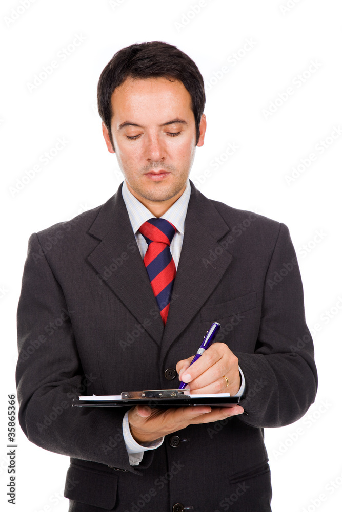 Portrait of thoughtful young business man taking notes against w Portrait of thoughtful young business man taking notes against w