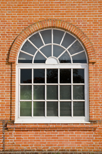 White painted wood arched window