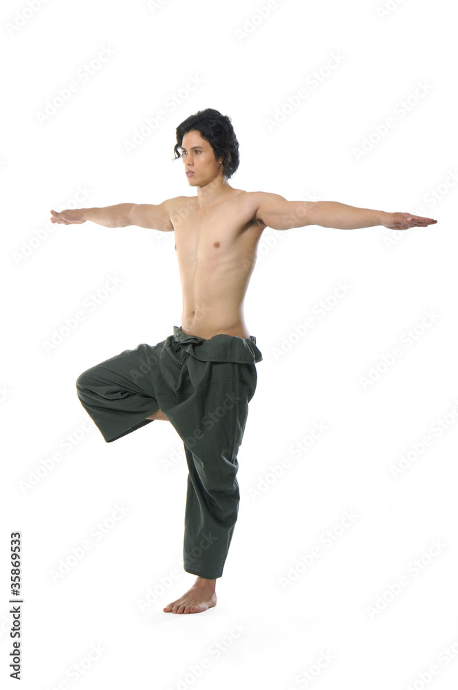 An attractive athletic man doing a yoga pose An attractive athletic man doing a yoga pose