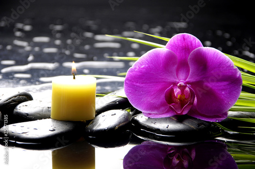 tranquil spa scene - burning spa candles with pink orchid