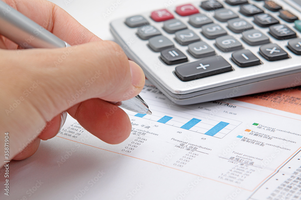Businessman's hand showing diagram on financial report with pen. Businessman's hand showing diagram on financial report with pen.