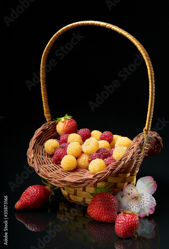 Pottle with berries on black