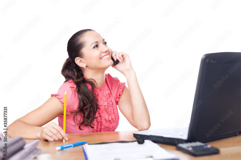 beautiful young woman sitting at office desk and talking on cell beautiful young woman sitting at office desk and talking on cell