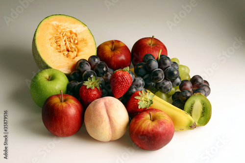 Delicious fresh ripe fruits on a gradient white background
