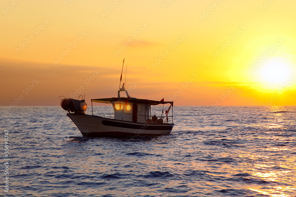fishing boat in sunrise at Mediterranean sea