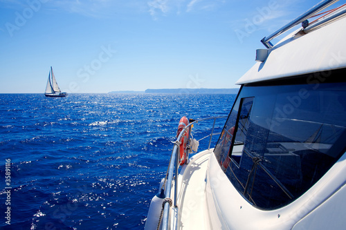 boat side view of blue ocean with sailboat © lunamarina