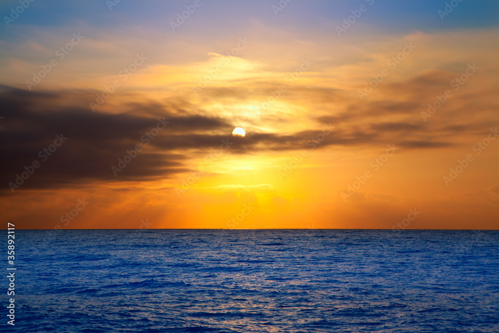 golden sunrise with sun and clouds over sea