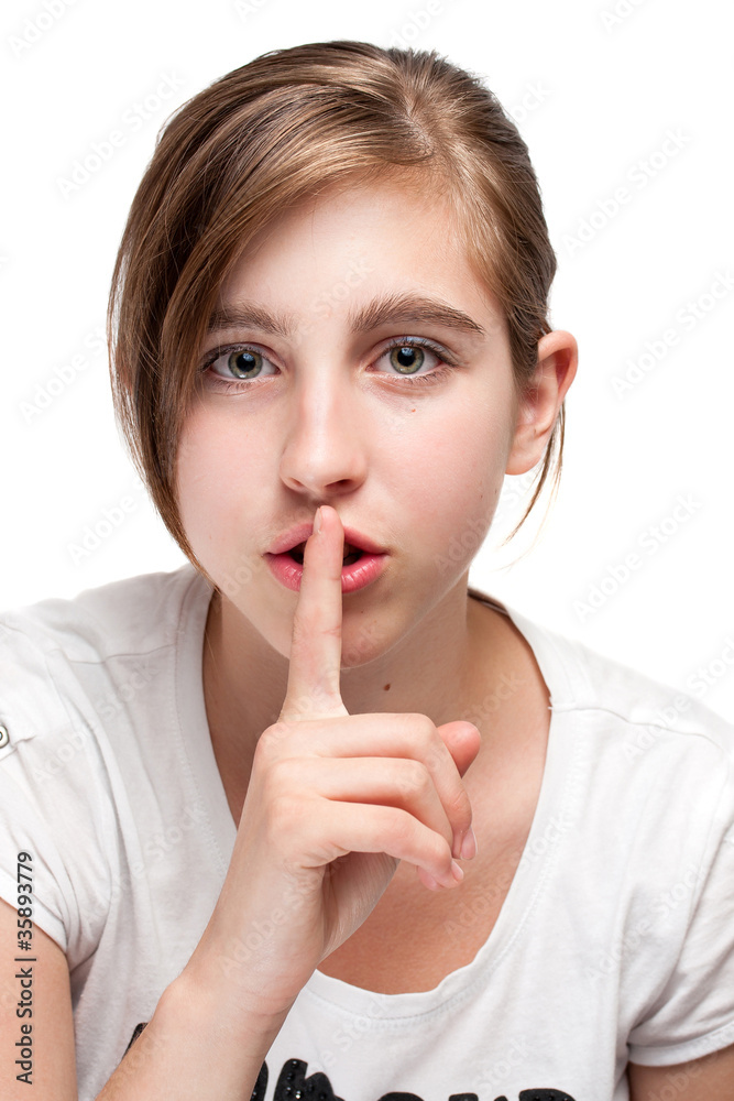 Portrait of young teen girl, gestures for silence Portrait of young teen girl, gestures for silence