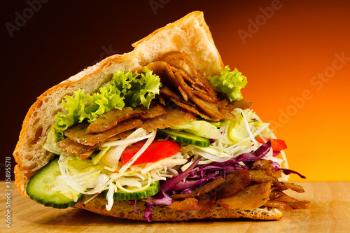 Kebab - grilled meat, bread and vegetables photo