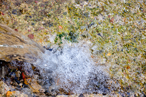 falling water in little waterfall in water spring