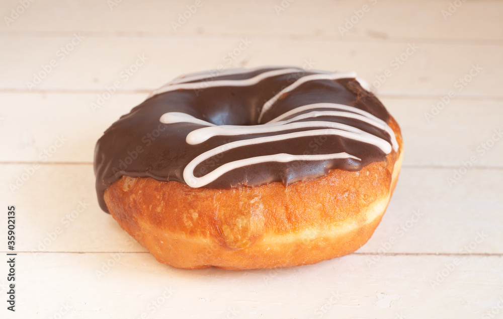 Donut covered in chocolate icing and sprinkles Donut covered in chocolate icing and sprinkles