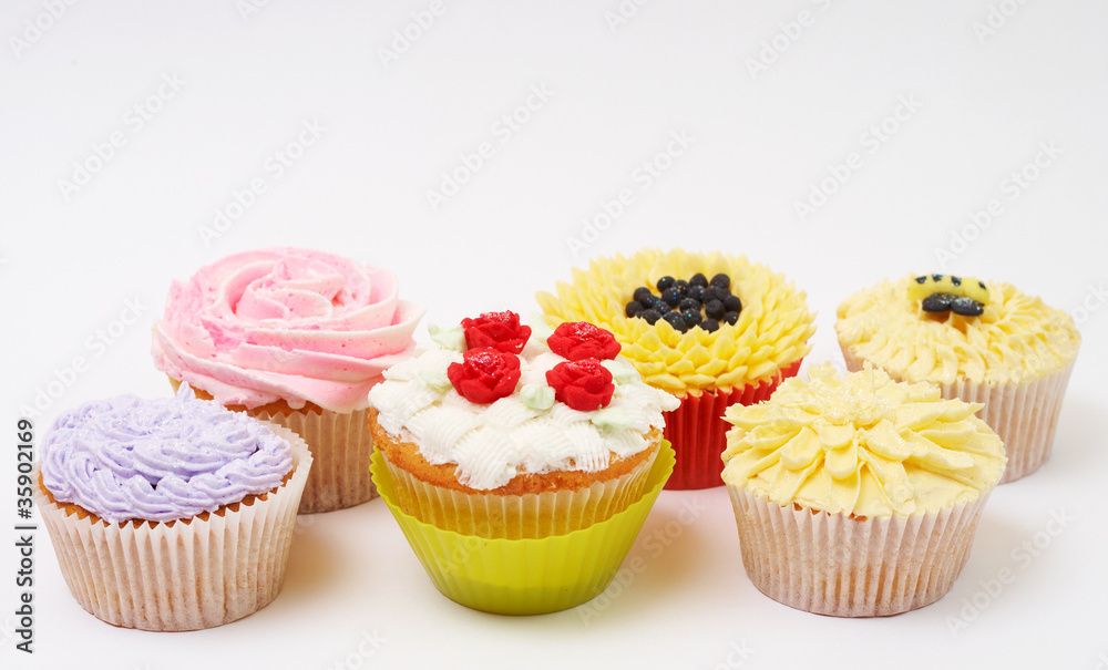 Variety of cupcakes with decorative techniques