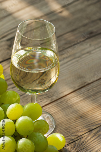 wine and grapes on wooden table