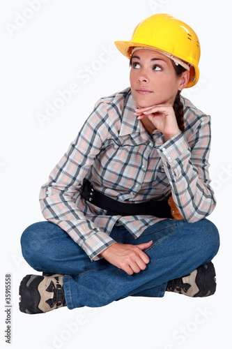 Woman laborer sitting on the ground