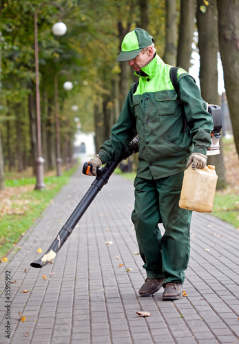 Landscaper cleaning the track using Leaf Blower