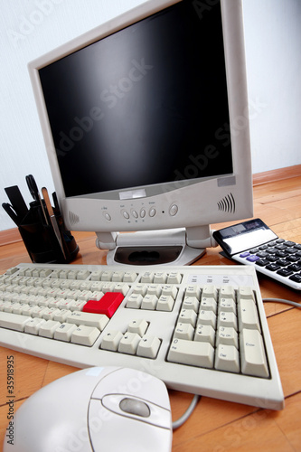 classic education or work place - keyboard and monitor at table